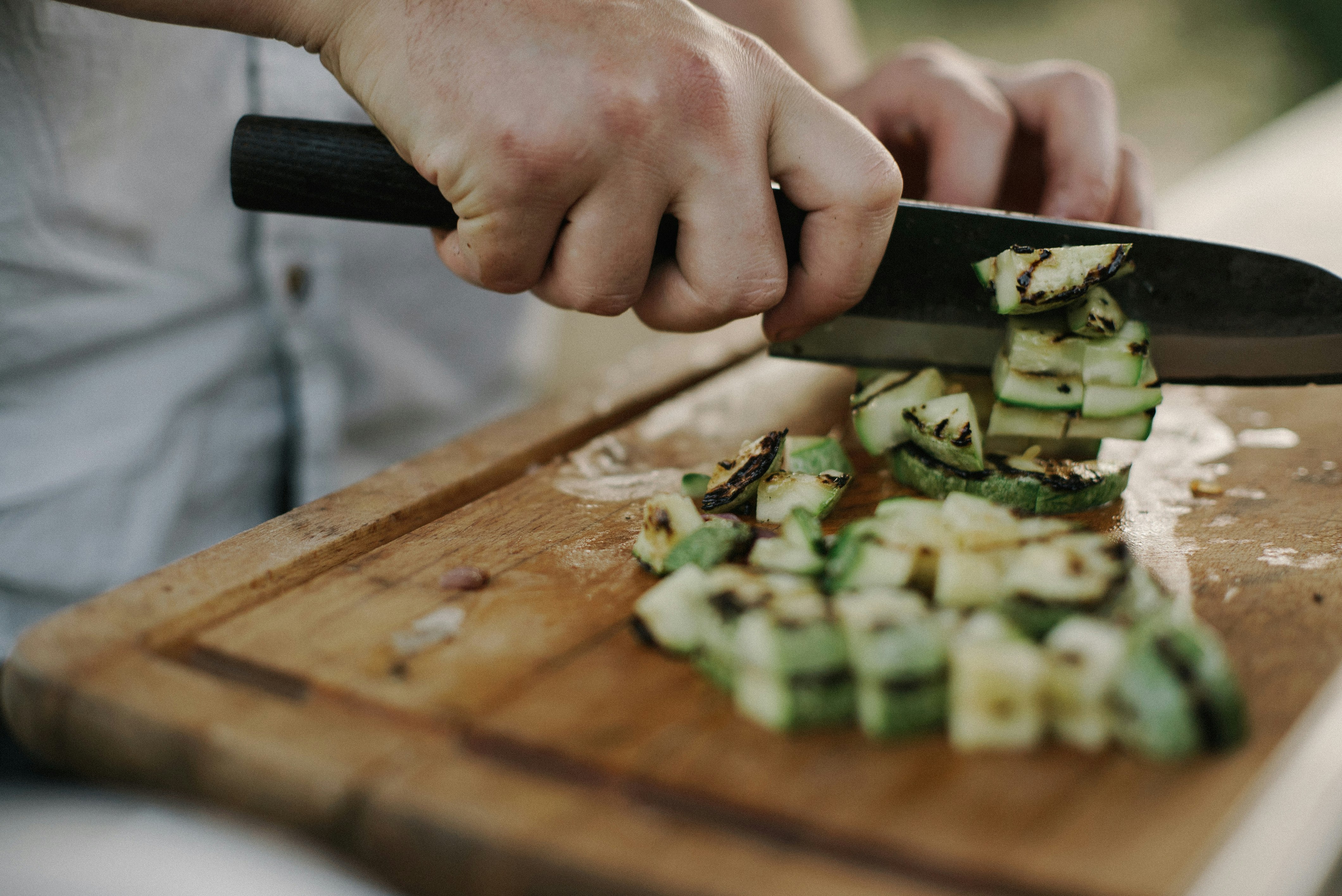 person slicing on the wooden board