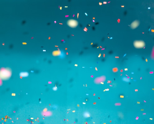 selective focus photography of multicolored confetti lot