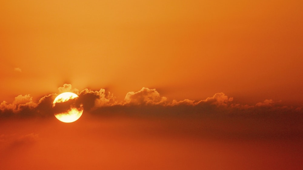 sun peak behind clouds