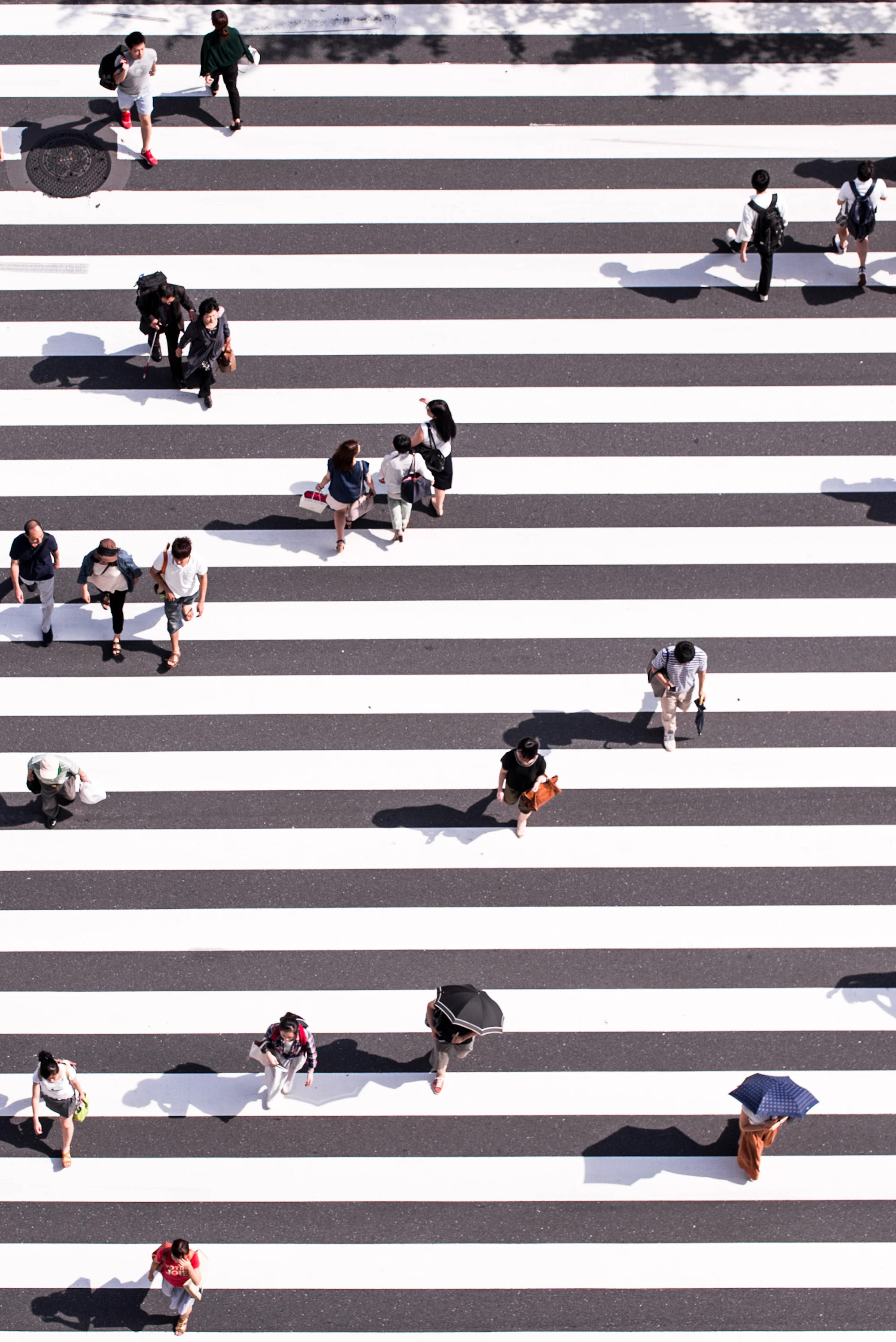 Aerial view of people crossing a wide zebra crossing