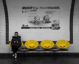 A smiling commuter using the CairoCommute app on their phone while waiting at a busy Cairo bus stop.