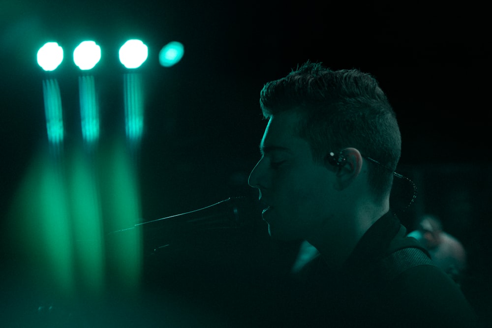 man wearing black shirt standing and wearing black earbuds