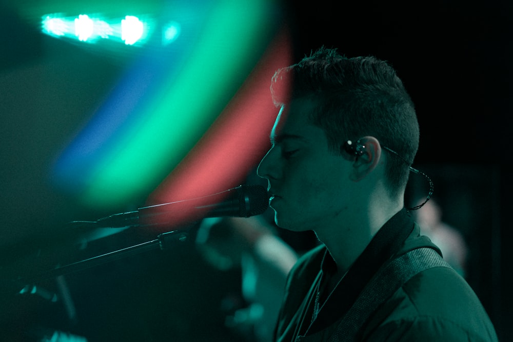 man standing in front of microphone