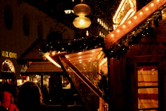 A warmly lit Christmas street scene in Moralzarzal with festive decorations and happy people.