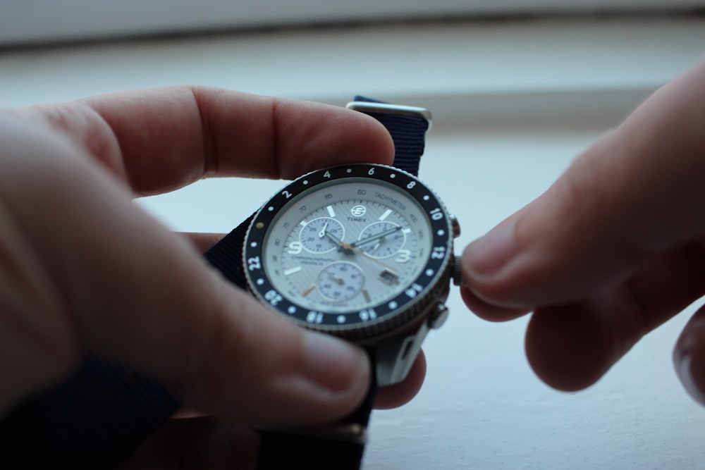 person setting the chronograph watch