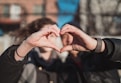 two person combine hand forming a heart hand gesture