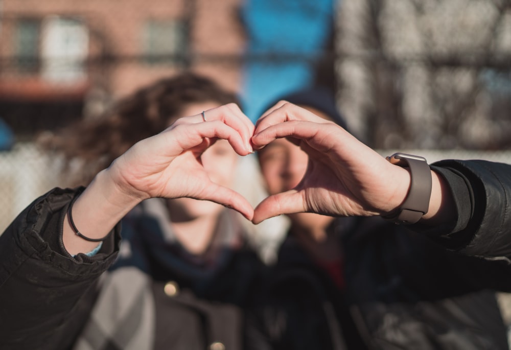 two person combine hand forming a heart hand gesture