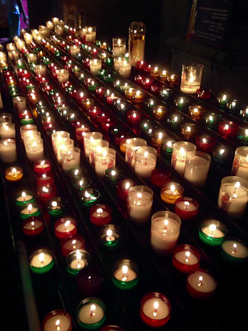 Rows of small, beautifully decorated candles ready to be gifted at a graduation party.
