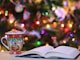 red and green ceramic mug beside book