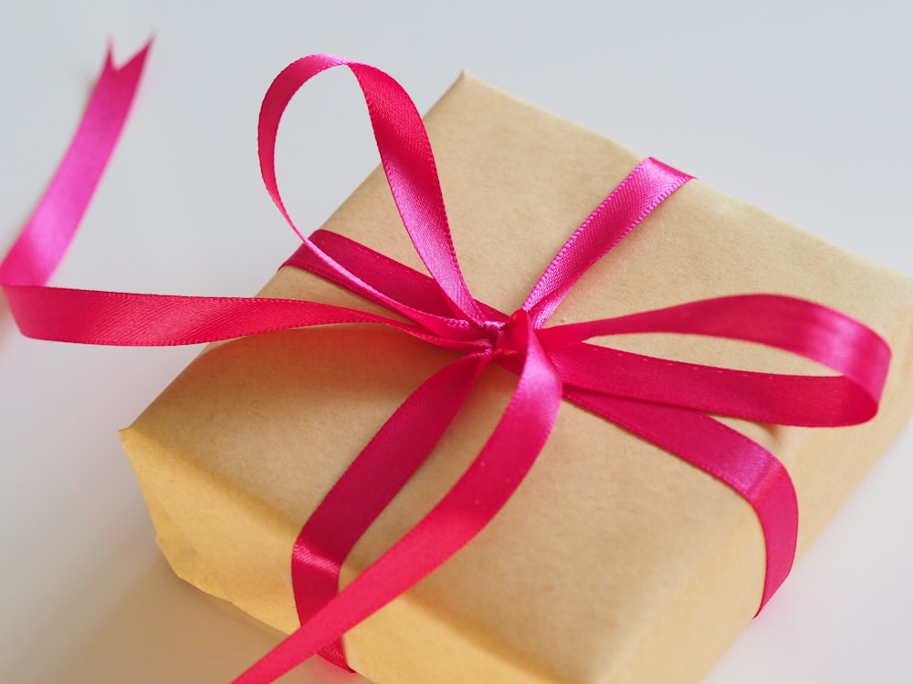 brown gift box with pink ribbon