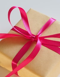 brown gift box with pink ribbon