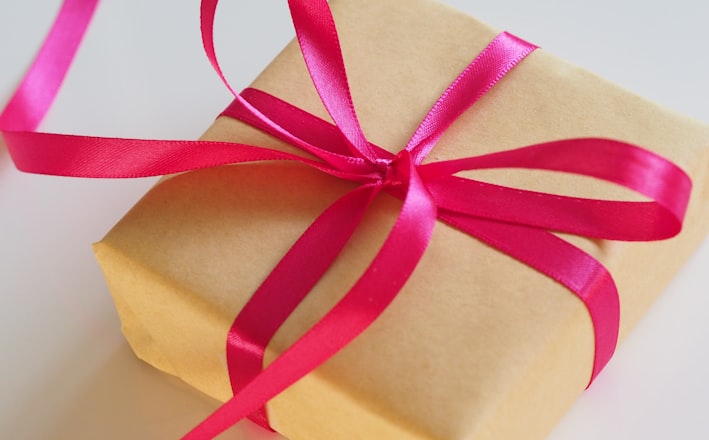 brown gift box with pink ribbon