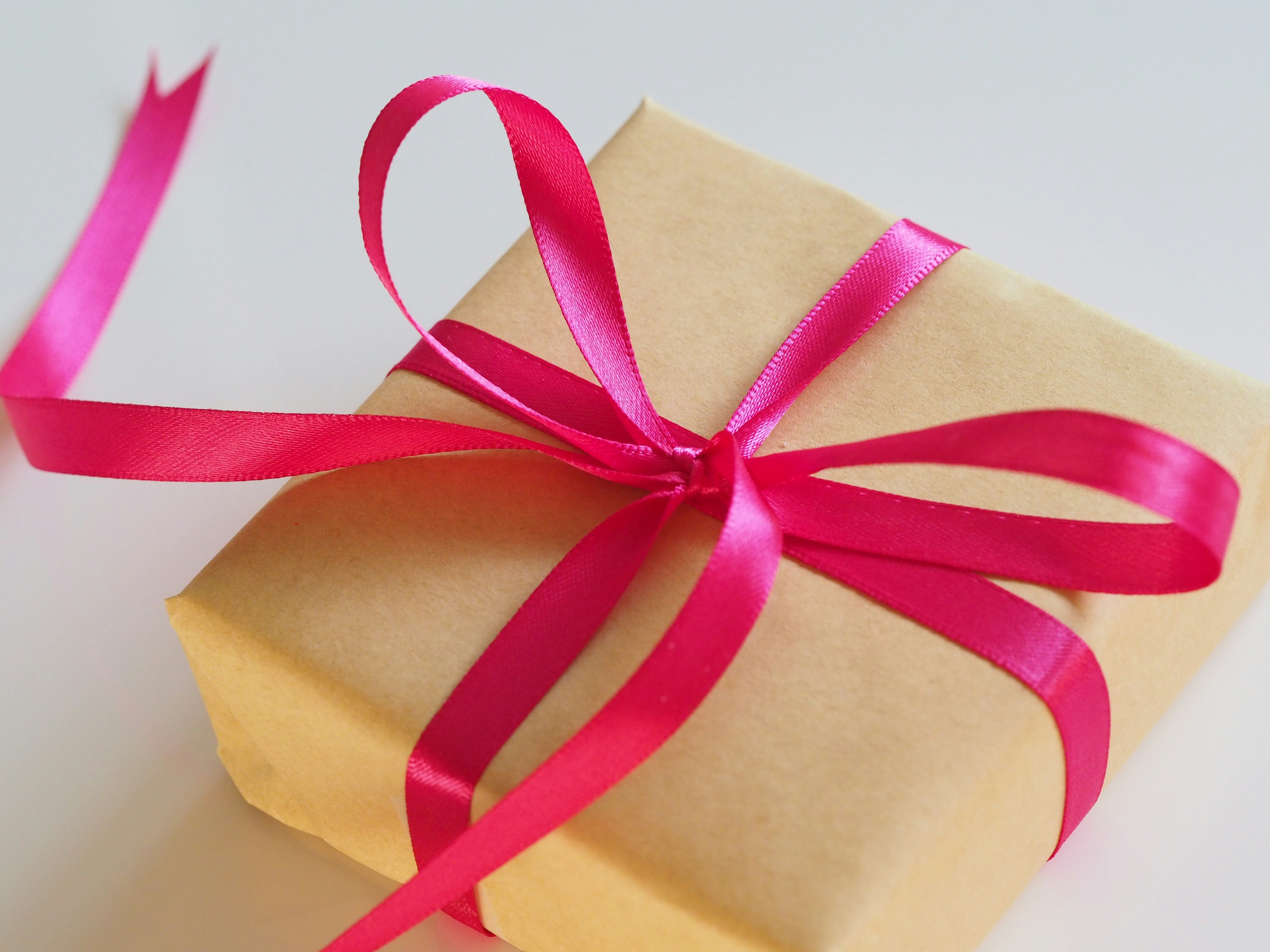 brown gift box with pink ribbon