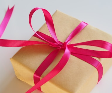 brown gift box with pink ribbon