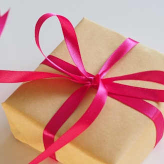 brown gift box with pink ribbon