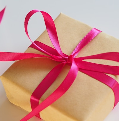 brown gift box with pink ribbon