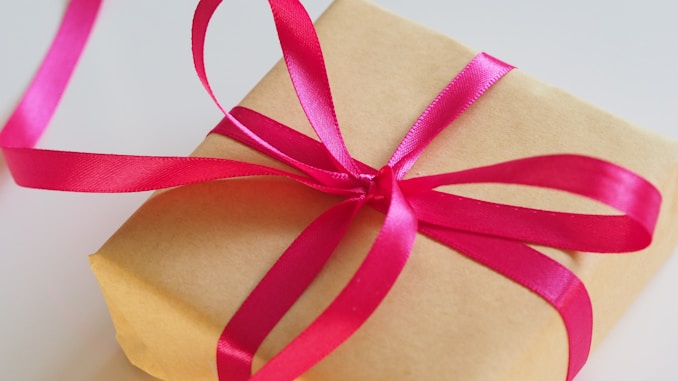 brown gift box with pink ribbon