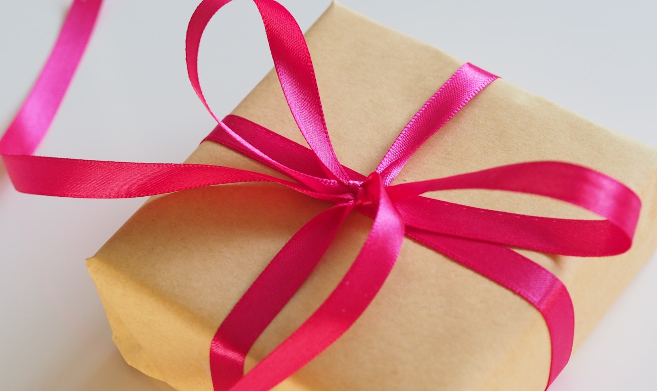 brown gift box with pink ribbon