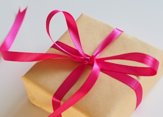 brown gift box with pink ribbon