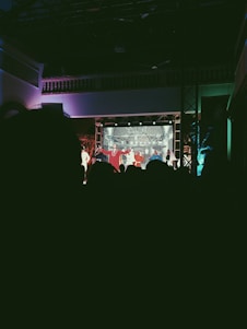 A lively theatre stage set for a performance with bright lights and colorful props.