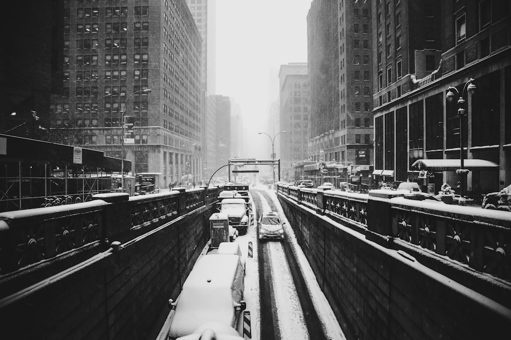 grayscale photograph of road covered by snow