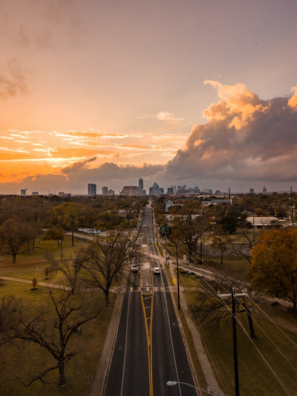 aerial view of highway road surrounded by trees during dawn