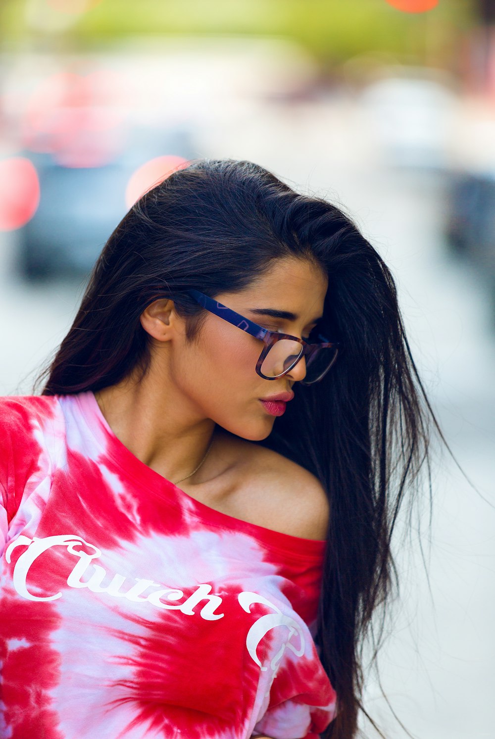 selective focus of woman wearing red and white floral top