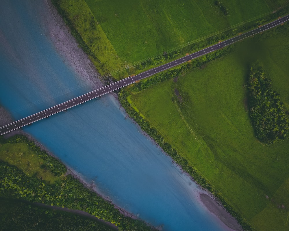 aerial photography of bridge near green grass field