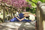 woman doing yoga on brown wooden bridge