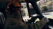 Close-up of a firefighter's helmet resting on a fire truck.