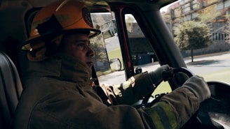 Close-up of a firefighter's helmet resting on the hood of the fire truck.