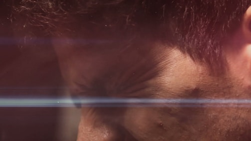 A cinematic frame from a documentary project, showing raw human emotion under moody lighting.