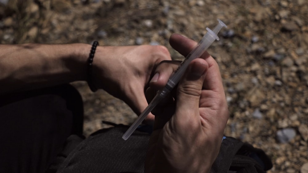 person holding syringe