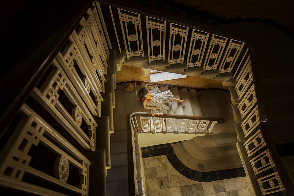 high angle photography of woman sitting on stairway