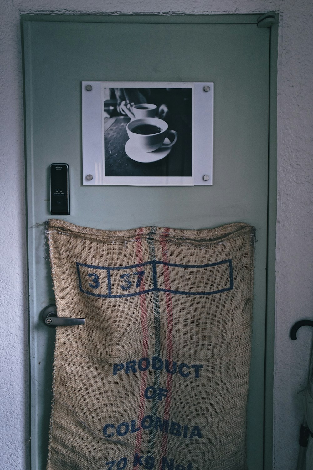 beige and black sack hanging on door