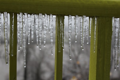 Icicles melting on a rooftop after bc icemelt application.
