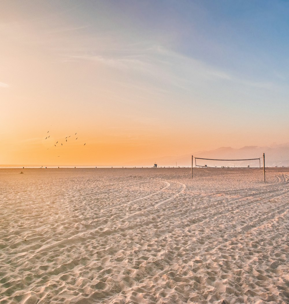 photo of volleyball net on sands