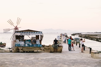 people standing near dock and store during daytime