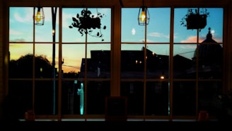 A calm night sky view through an office window, with deep navy and soft gold tones reflecting inside.