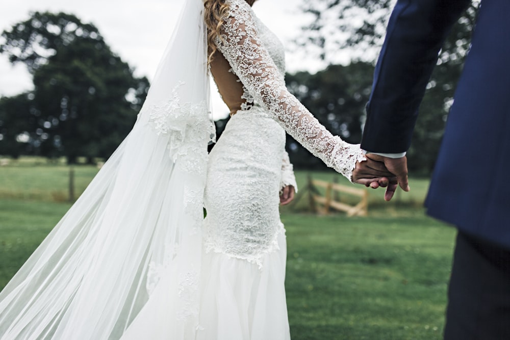 bride and groom holding hans