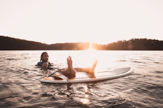 man floating on body of water