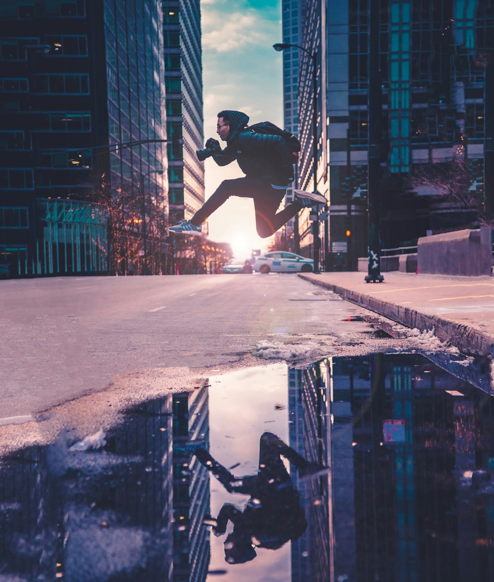 man running across street with buildings