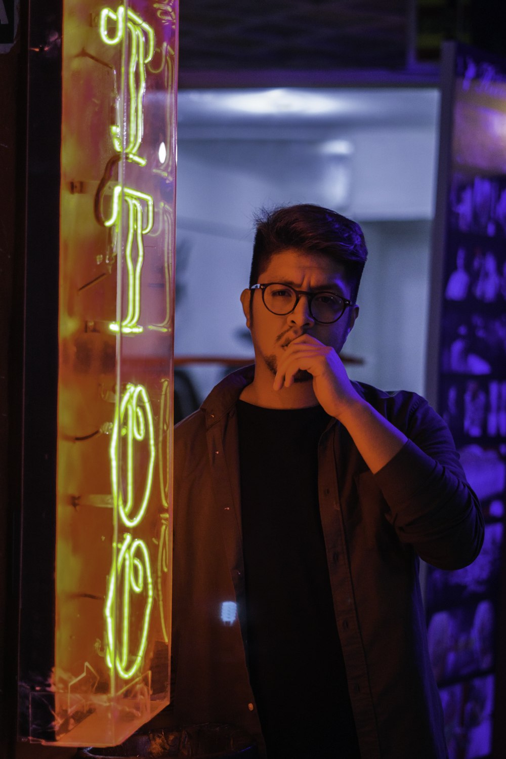 person standing beside turned on yellow neon pub signage