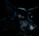 A portrait of a black dog captured in low light, highlighting its piercing red eyes and shiny coat. The shadows accentuate the dog's features against the dark background, creating a dramatic and mysterious effect.