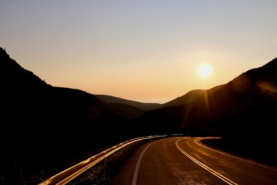 road between mountains during sunset in Cabot Trail Canada