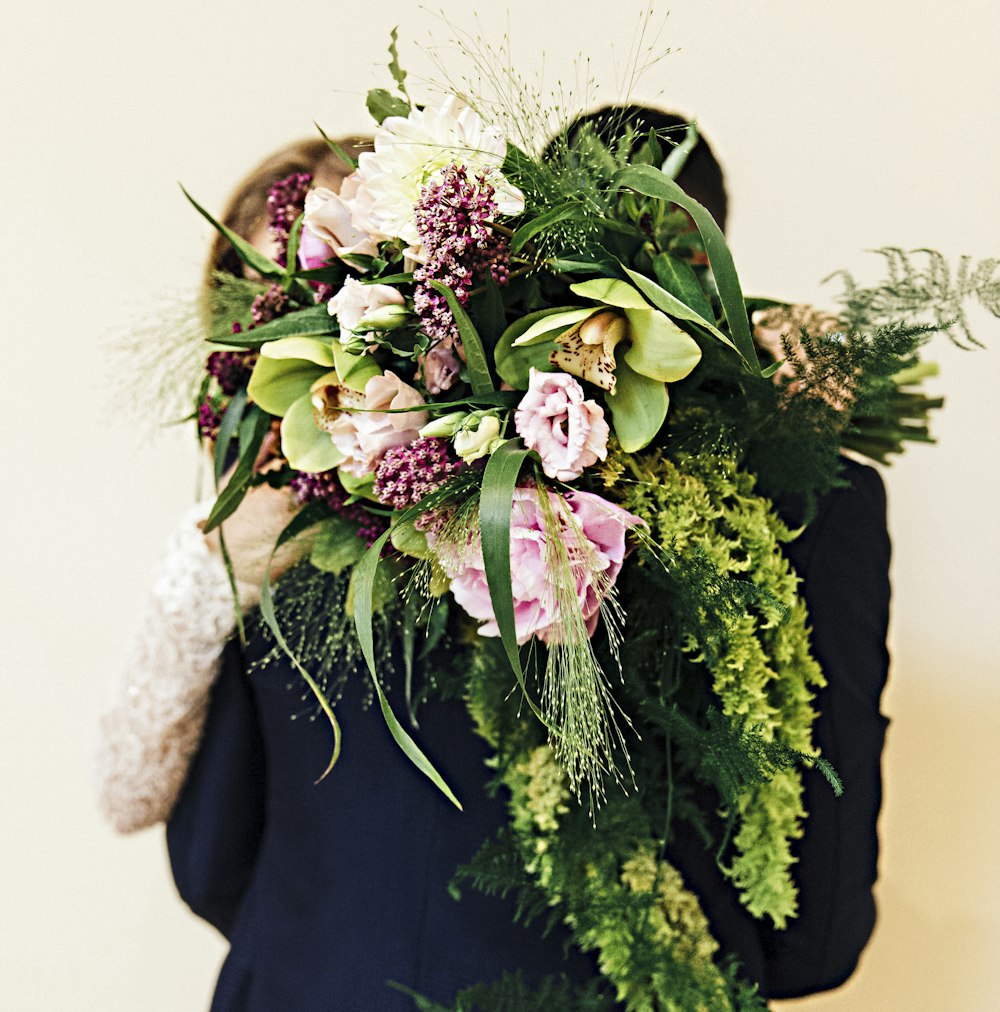 woman holding flower bouquet hugging man