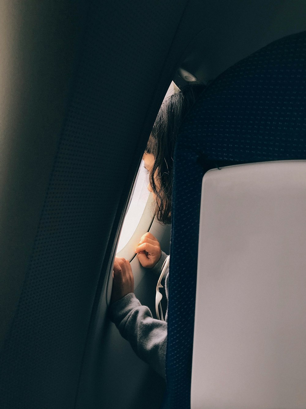 a woman sitting in a seat on an airplane