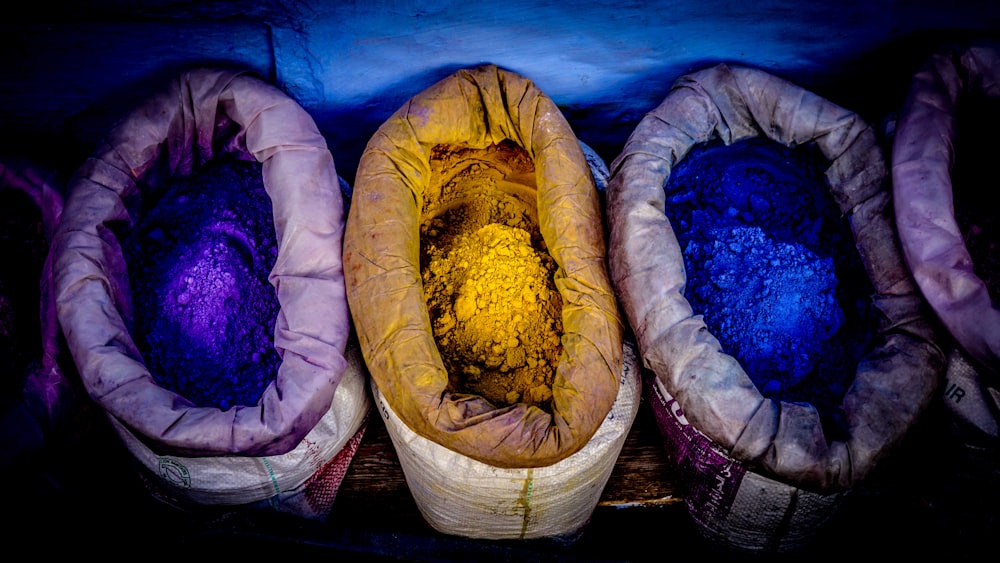 three assorted-color powder sacks