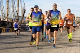 people running on gray soil near boat