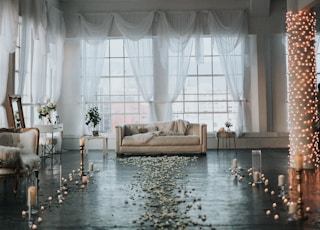 beige sofa in white sheer curtained room